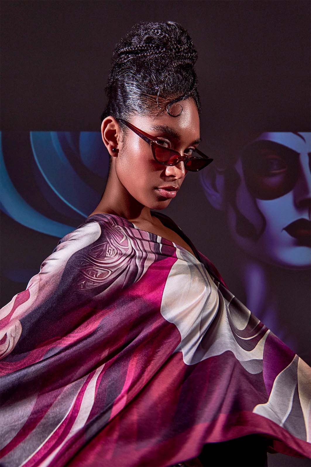 Close-up of Freeque’s Écorché luxury scarf, revealing intricate surrealist detailing and rich maroon hues.