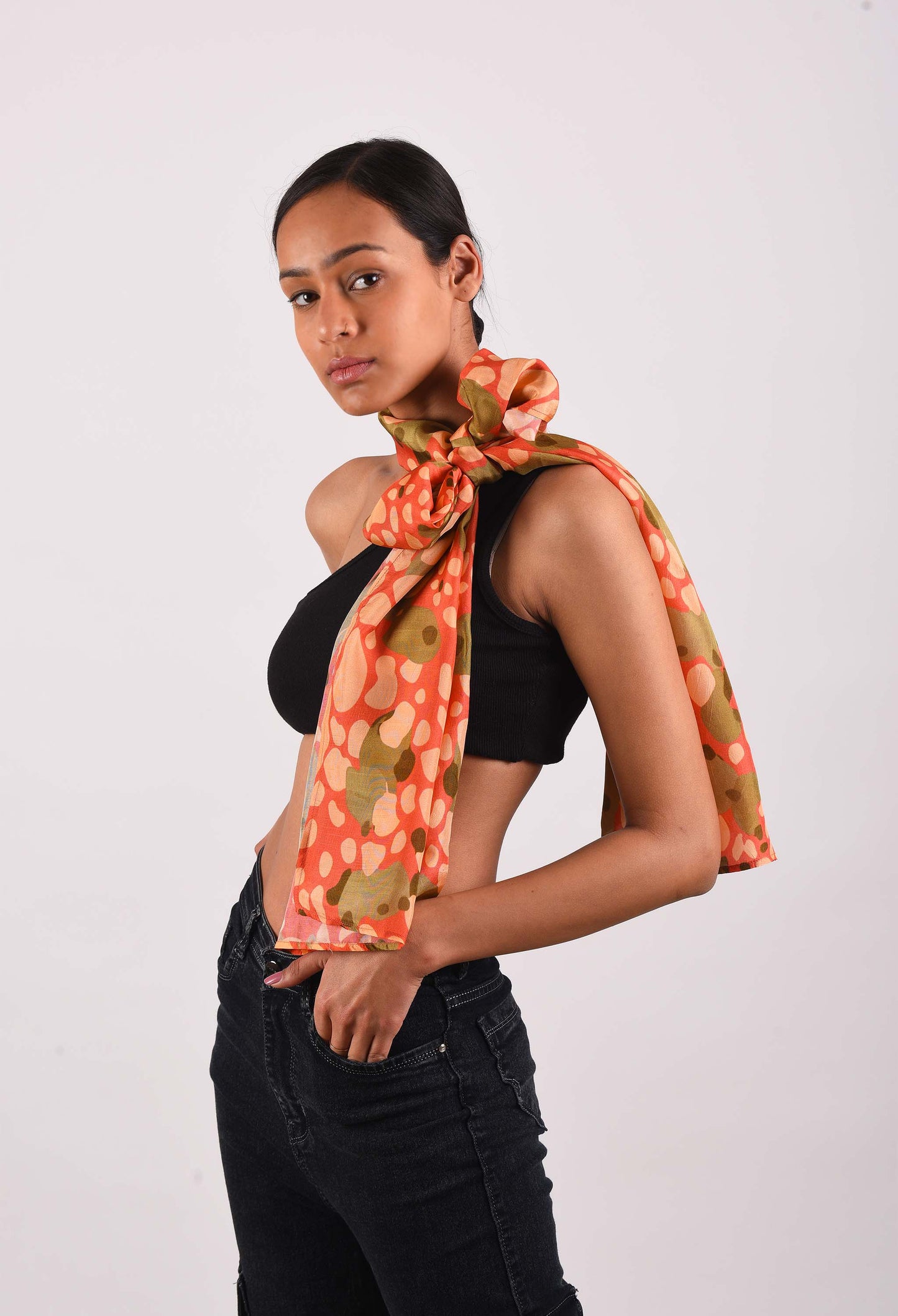 Model wearing Strawberry Lush scented stole in vibrant orange and green tones.