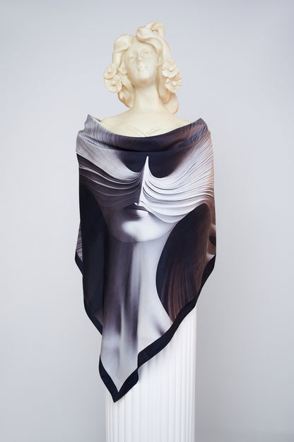 L'Esprit Fluctuant luxury scented scarf by Freeque draped on a sculpture, showcasing abstract artistry in black silk.