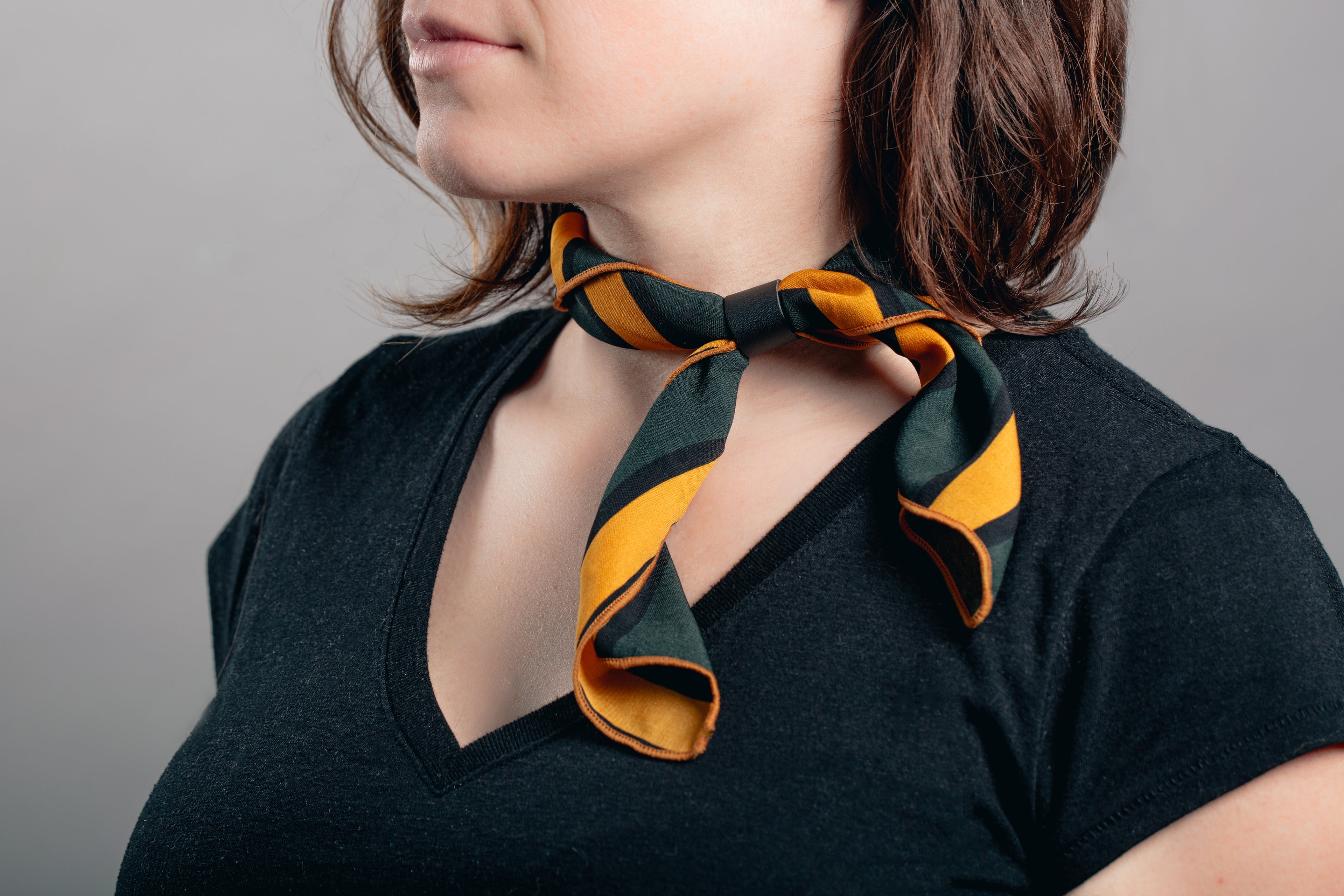 model wearing a luxury scented scarf around her neck in a bow