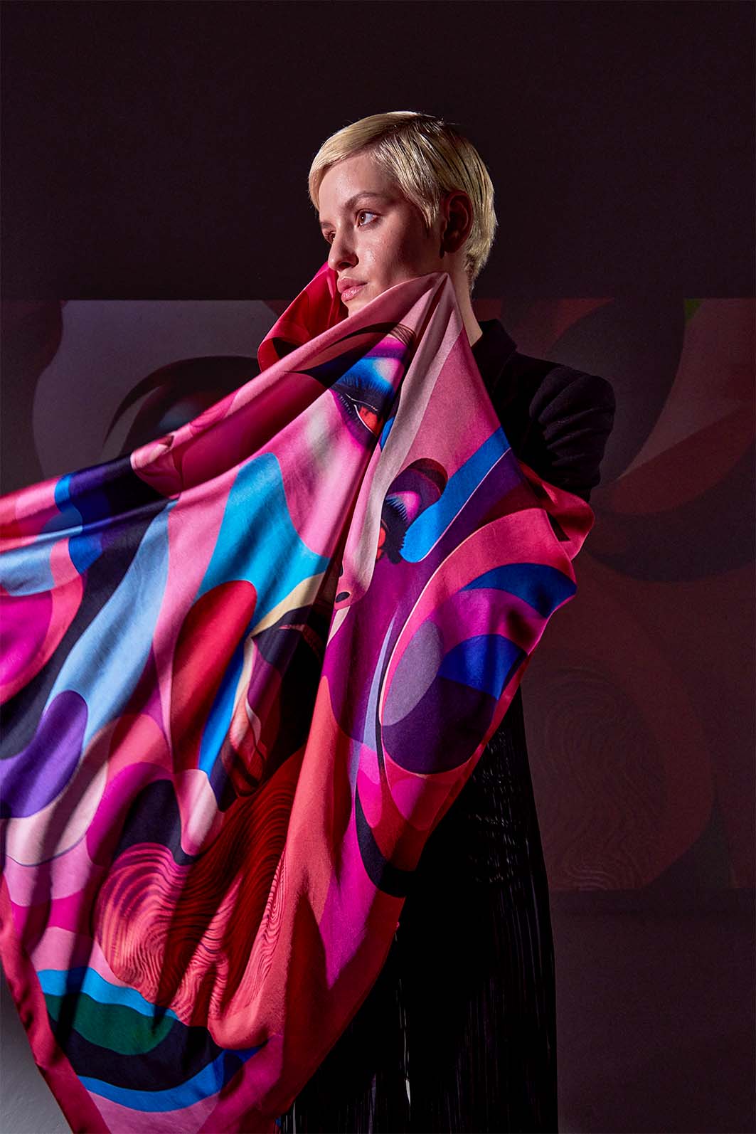 Flowing Rêve d’Amour luxury scarf in motion, enveloping the model in an ethereal swirl of silk and color.