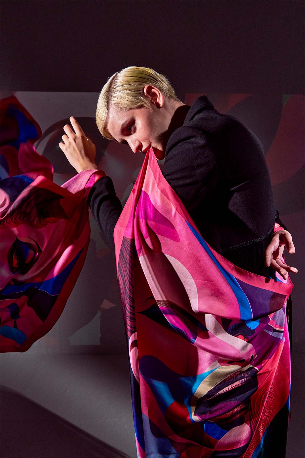 Model wearing Freeque’s Rêve d’Amour scented scarf, showcasing its fluid silk drape and artistic surreal design.
