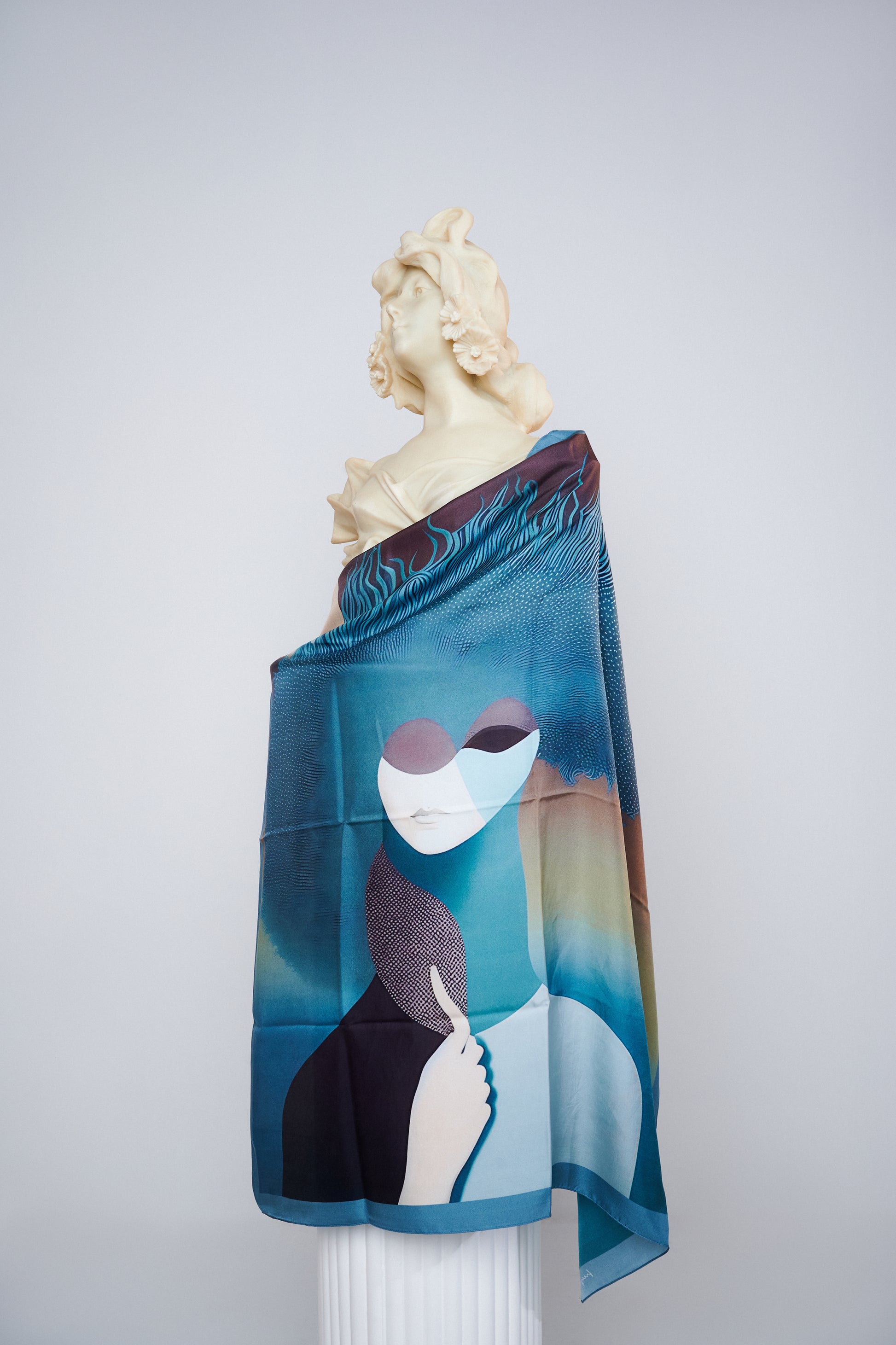 Skepsis Doubt scented silk scarf draped on statue, inspired by Rene Magritte's surrealism