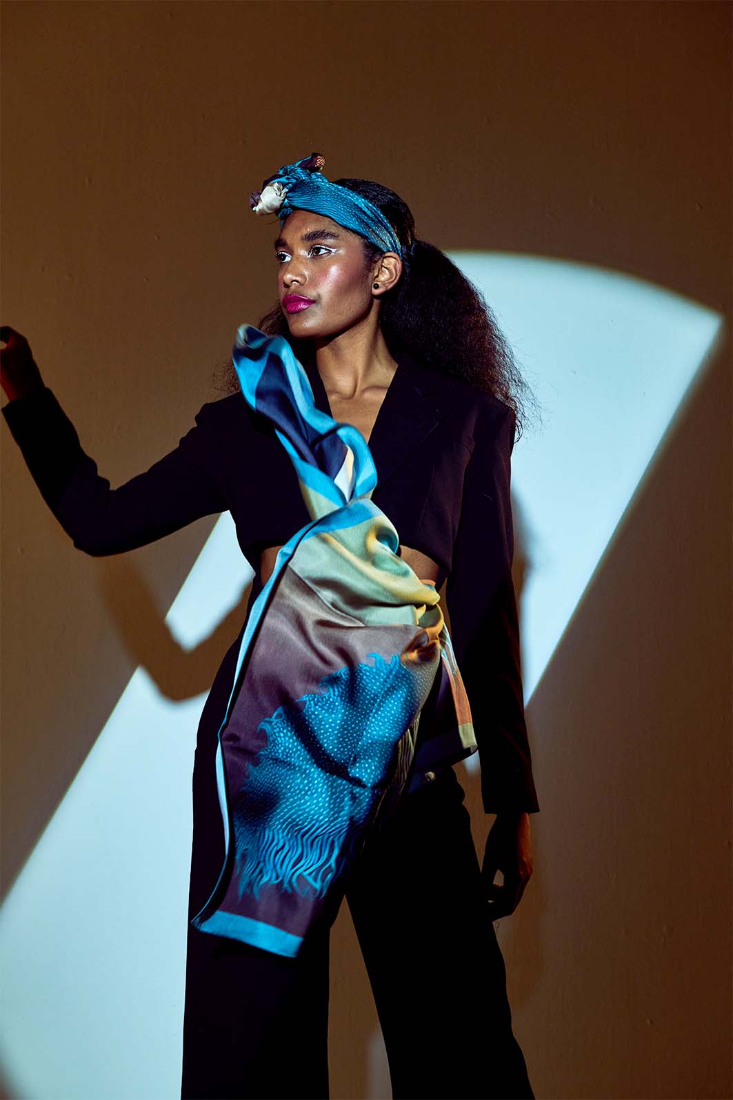 Model posing with Skepsis Doubt scented scarf in dramatic lighting, teal surrealistic design