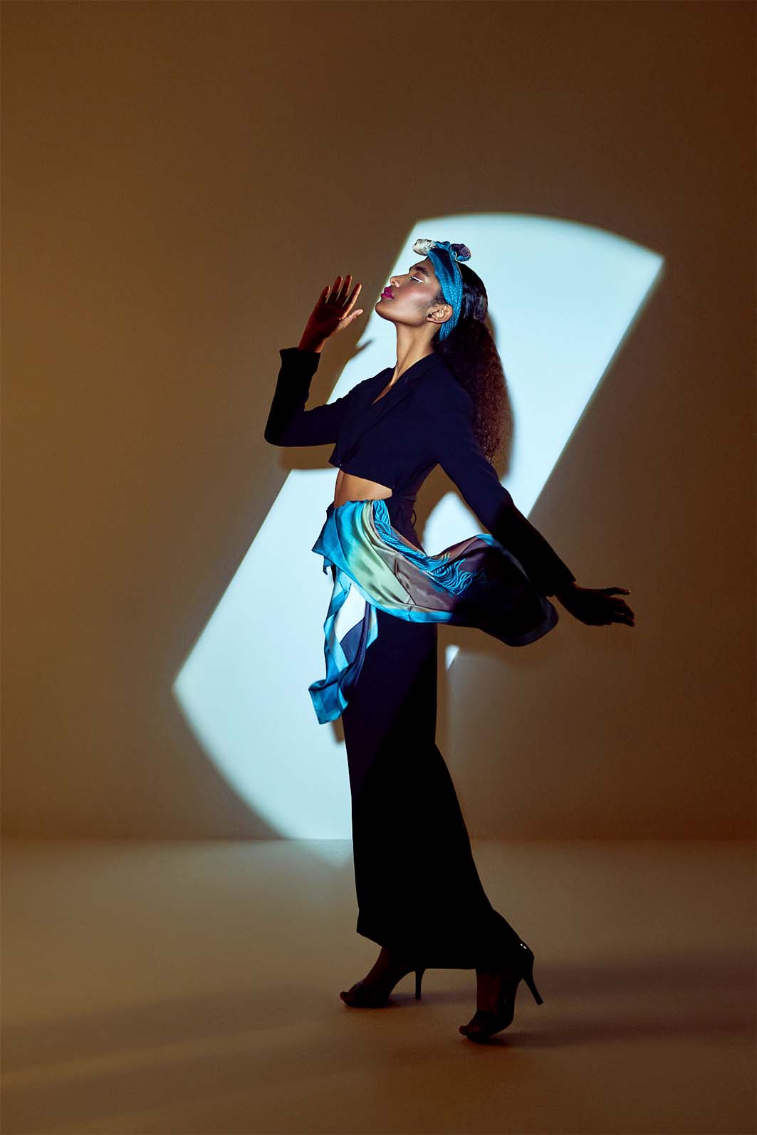 Model wearing Skepsis Doubt scented silk scarf from Freeque's Hygieia Collection, surrealistic design in teal
