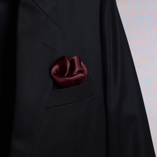 Solid burgundy satin silk pocket square in suit jacket pocket – luxury accessory by Freeque.
