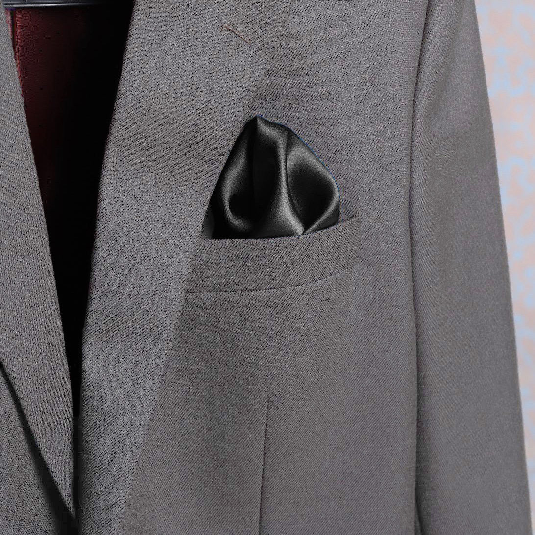 Solid charcoal scented satin silk pocket square in a suit pocket - luxury accessory by Freeque.