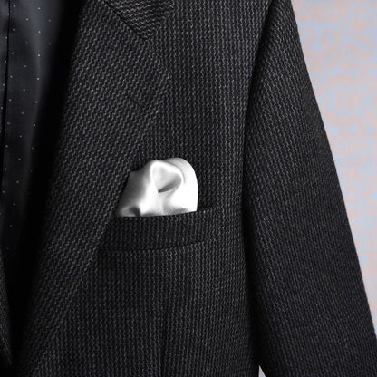 Solid white scented pocket square styled in a suit pocket - luxury accessory by Freeque.