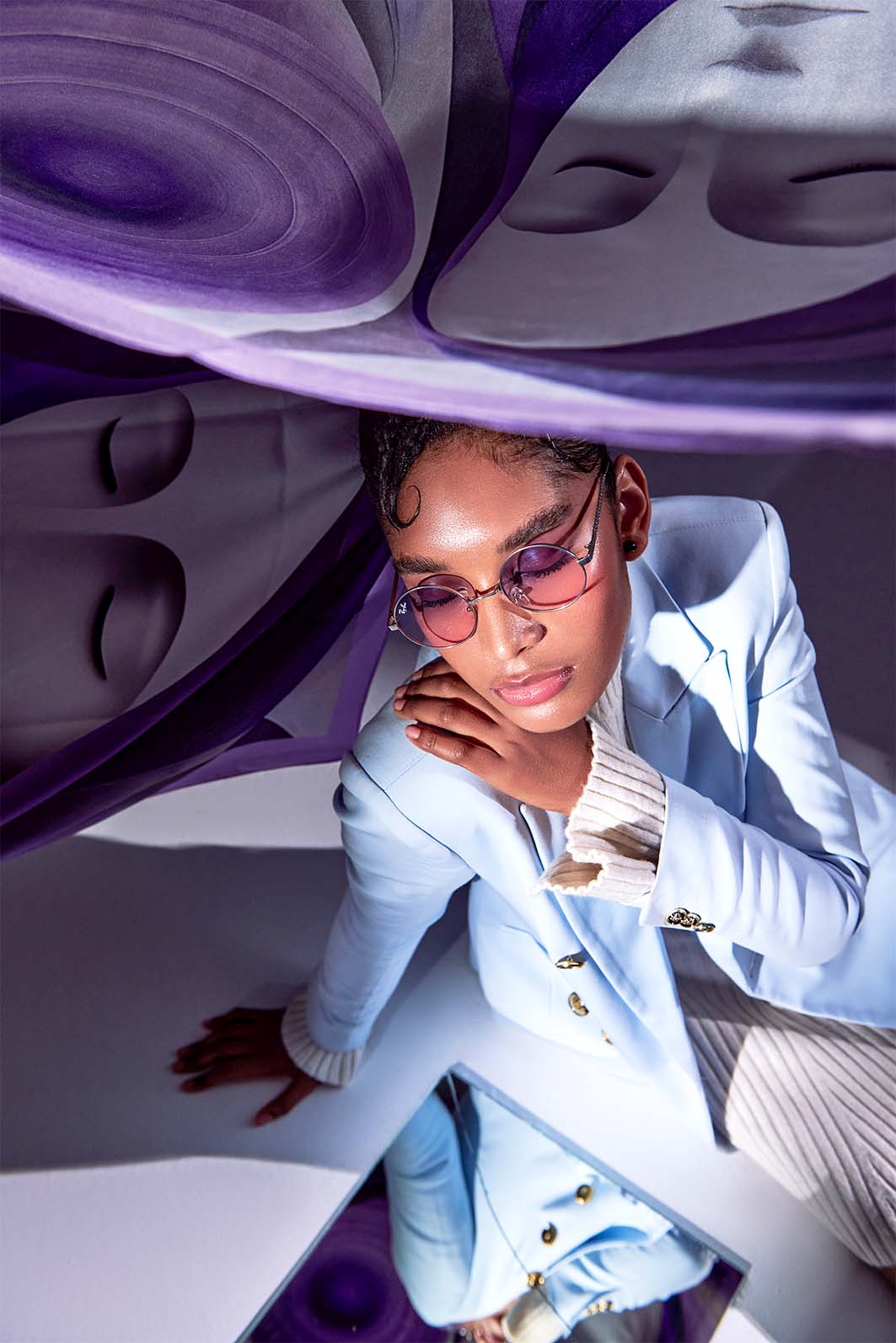 Model styled in Voile D’Ombre, Freeque’s luxury silk scarf with an ethereal face motif in purple hues.