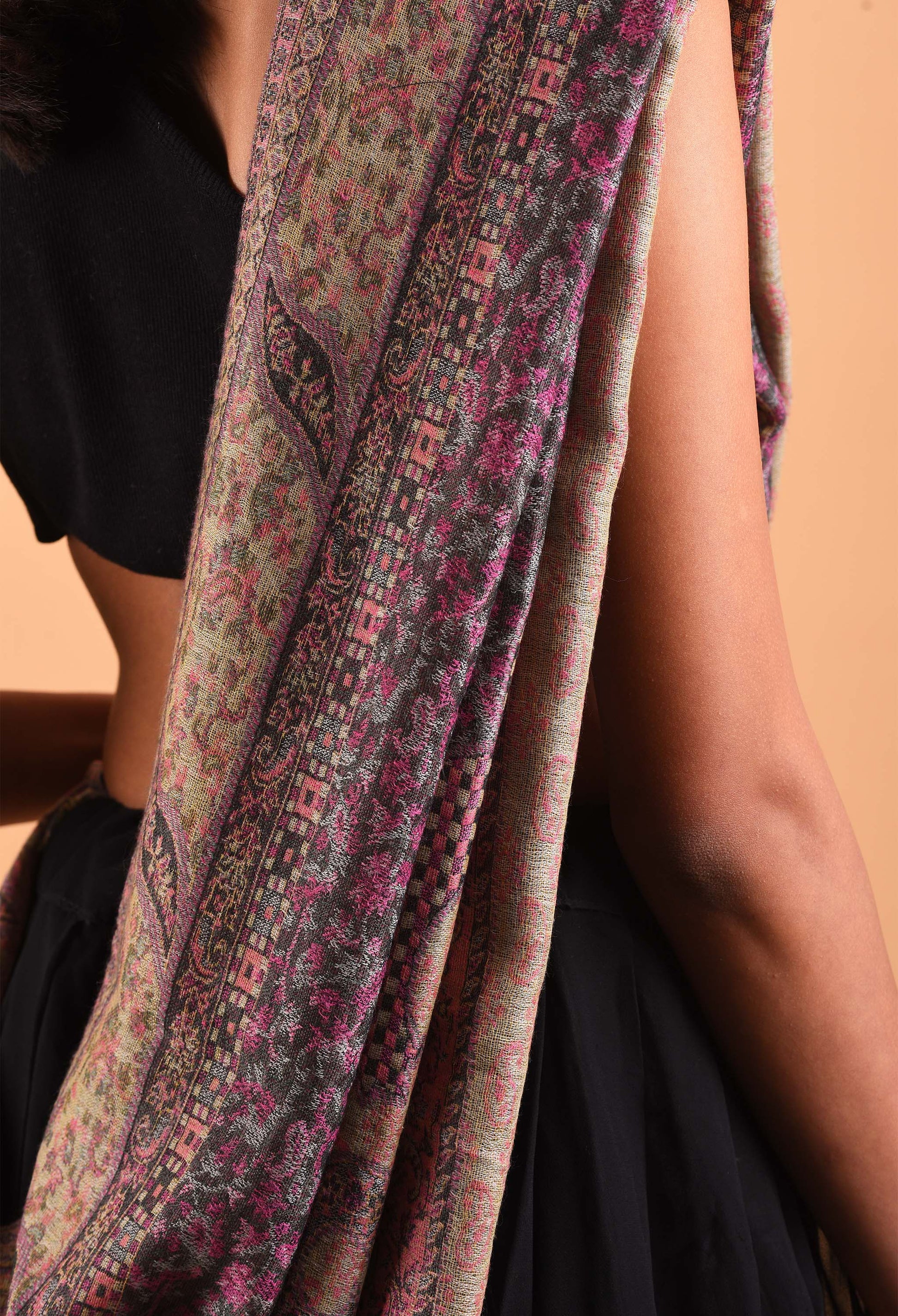 Aidha camel wool shawl with intricate patterns draped over shoulder, luxury Indian textile.