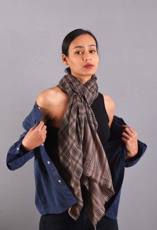 Model wearing Asher stole in camel wool, styled with a gray jacket, showcasing unisex elegance and luxury.
