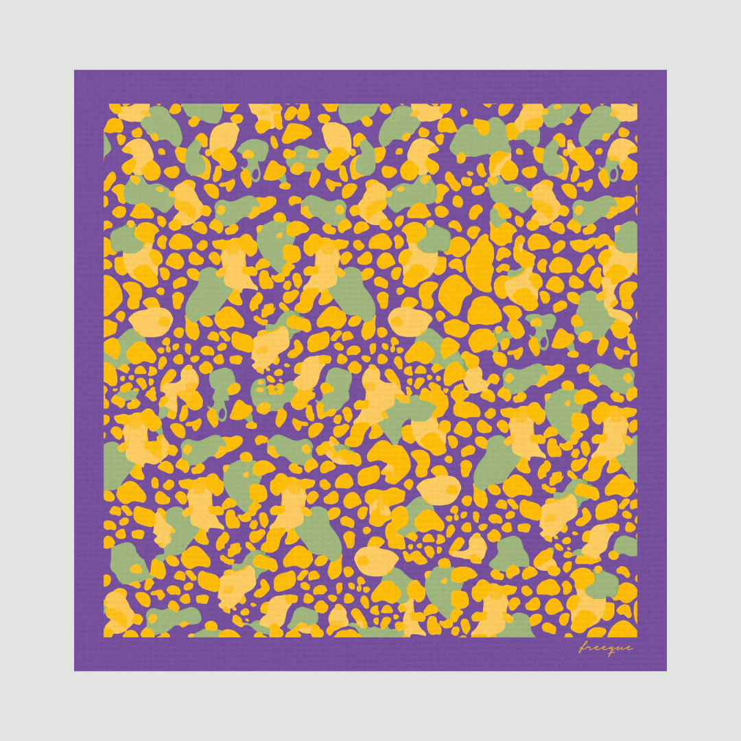 Flat-lay image of Auber'genius scented scarf displaying abstract yellow and purple pattern with green accents