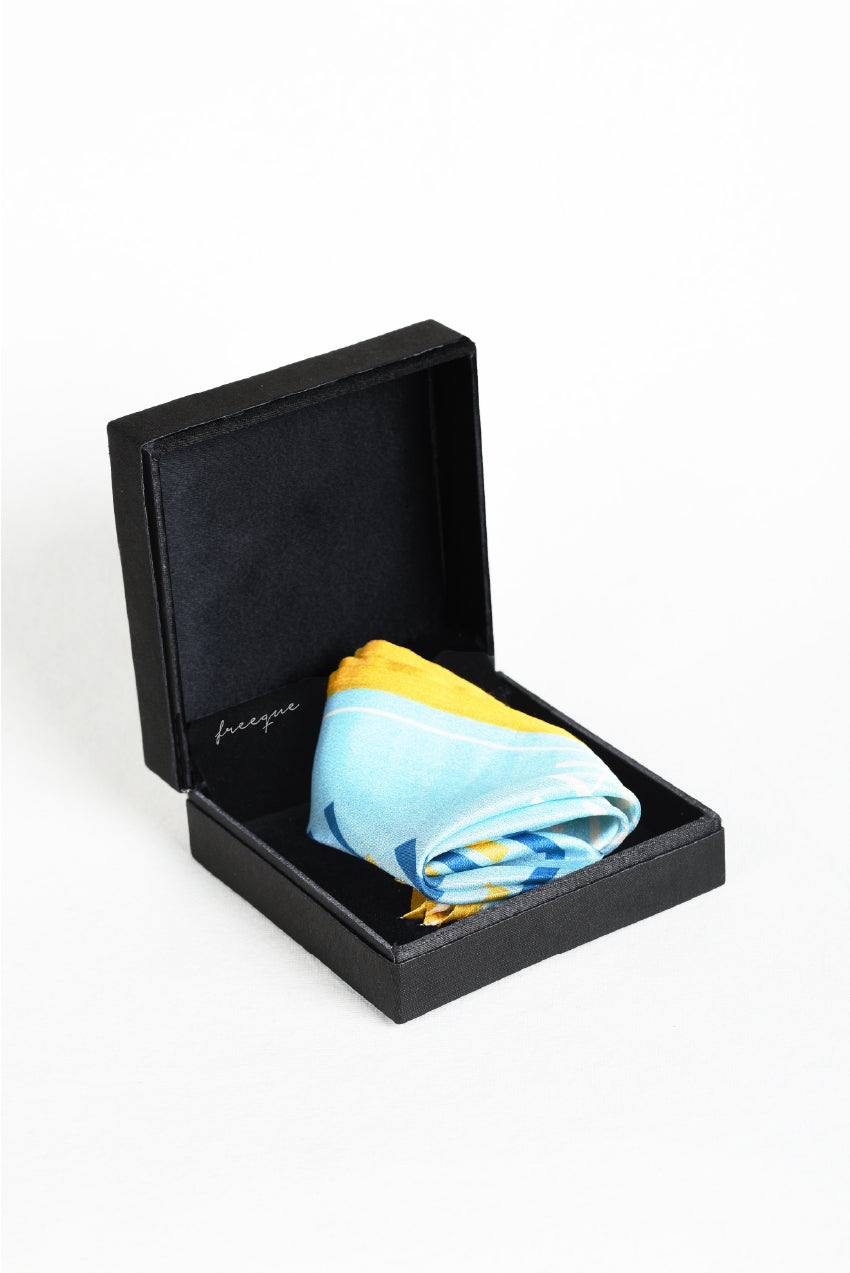 Pocket square in blue and yellow stripes displayed in a box.