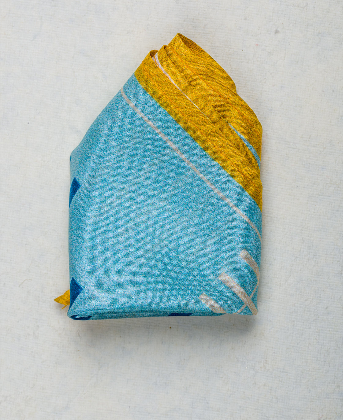 Folded blue and yellow striped pocket square close-up.