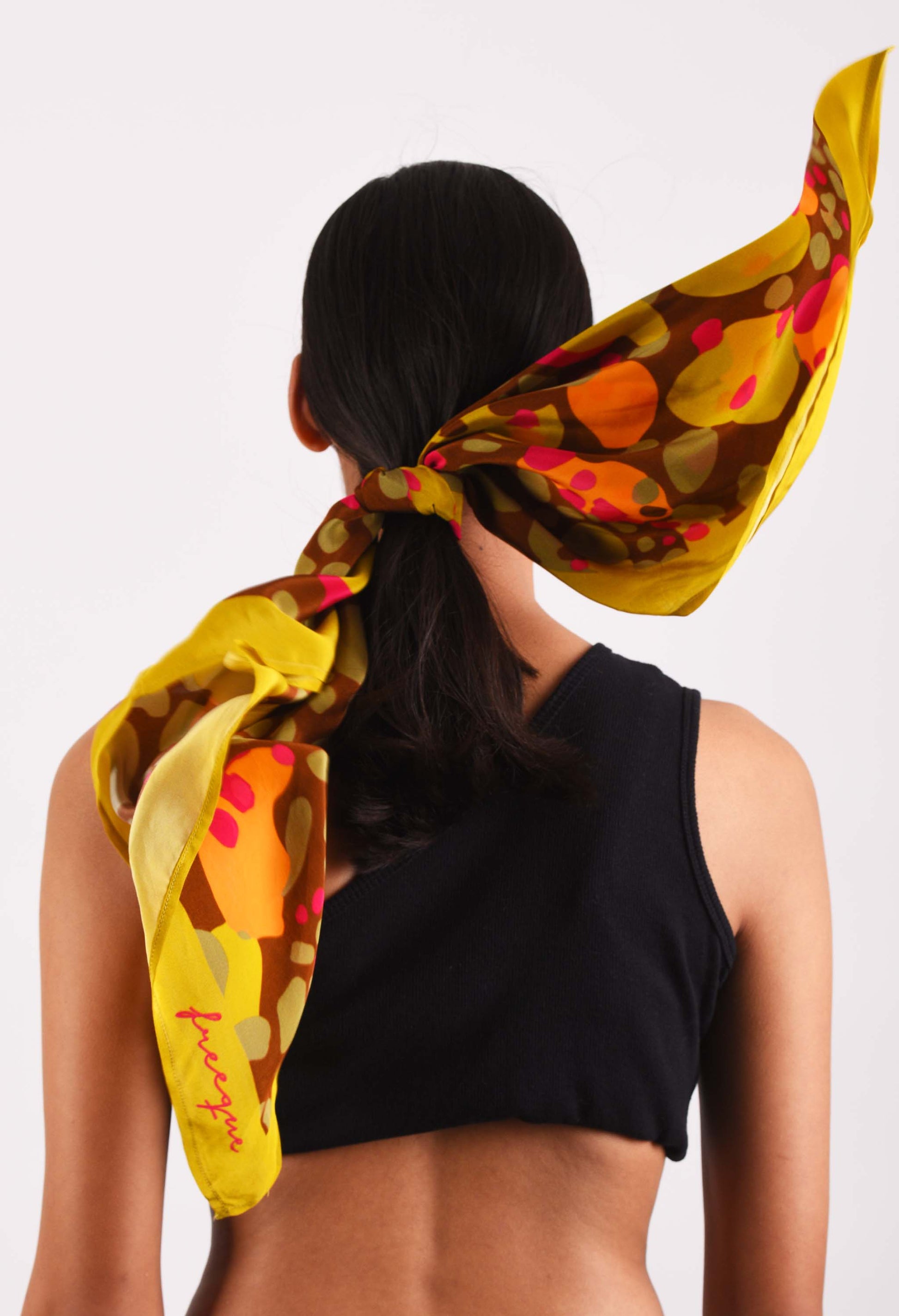 Model with Bubblegum scarf tied at the back, showcasing bold colors