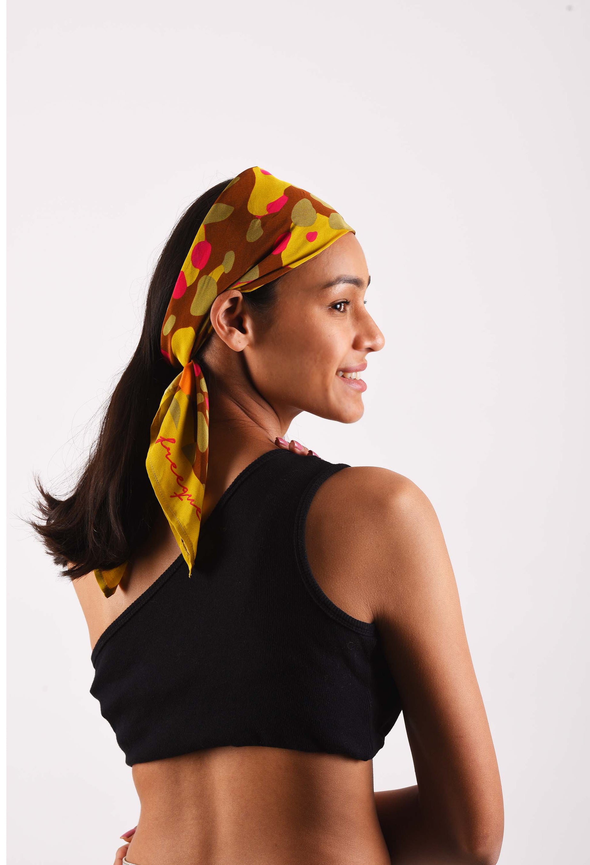 Model wearing Bubblegum scented scarf in vibrant colors, styled as a headscarf