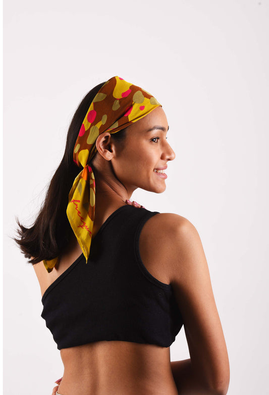 Model wearing Bubblegum scented scarf in vibrant colors, styled as a headscarf