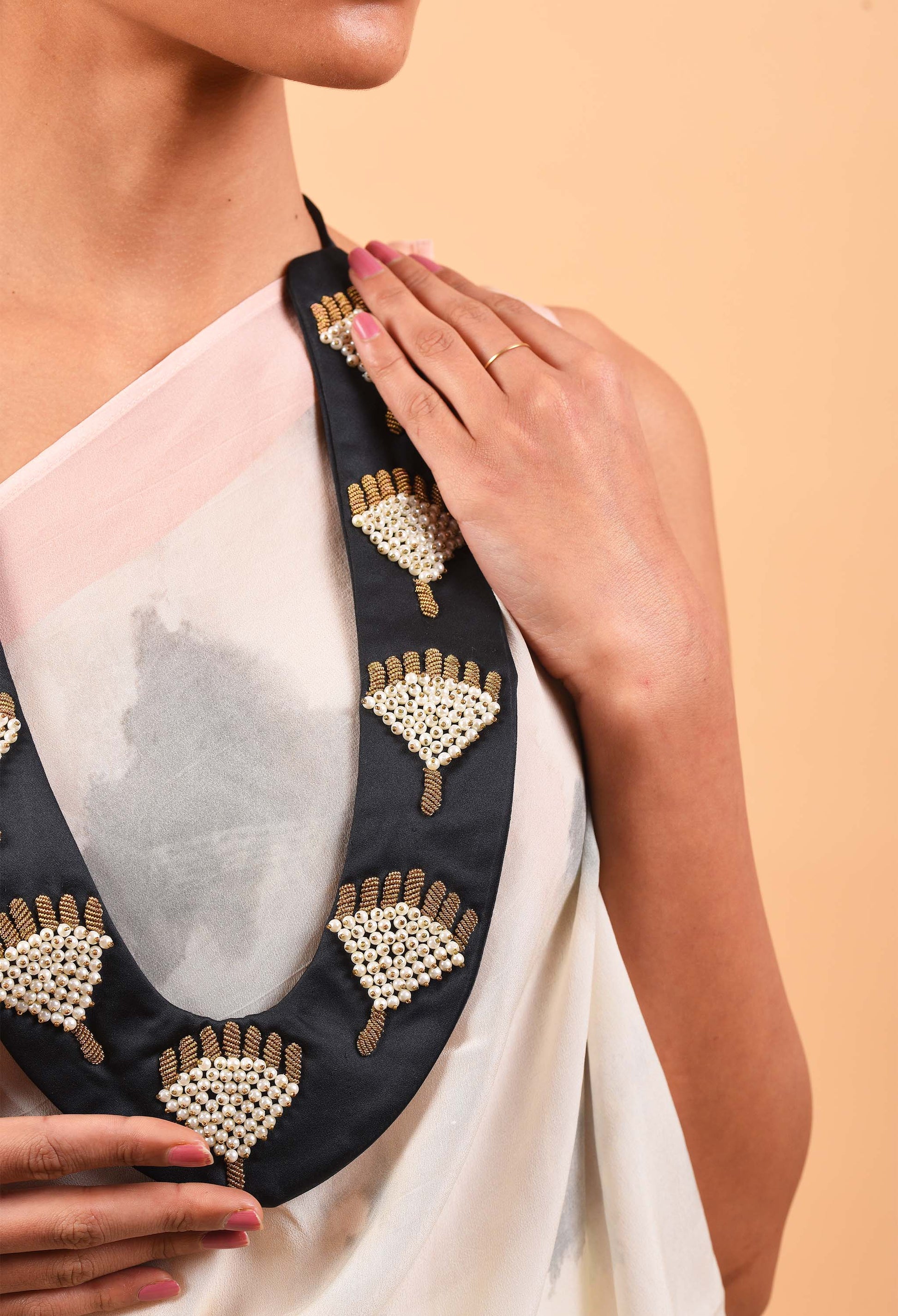Close-up of Courtesy jewellery piece on model, highlighting its unique design and fine beadwork inspired by Indian traditions.