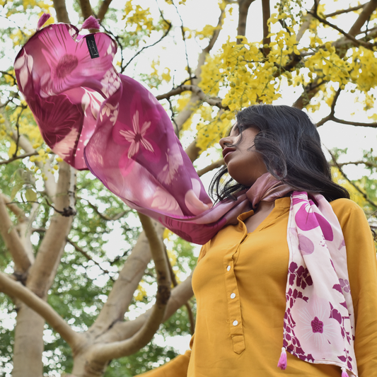 Woman wearing Di-wine Florist luxury scented scarf in lavender and pink hues, flowing outdoors