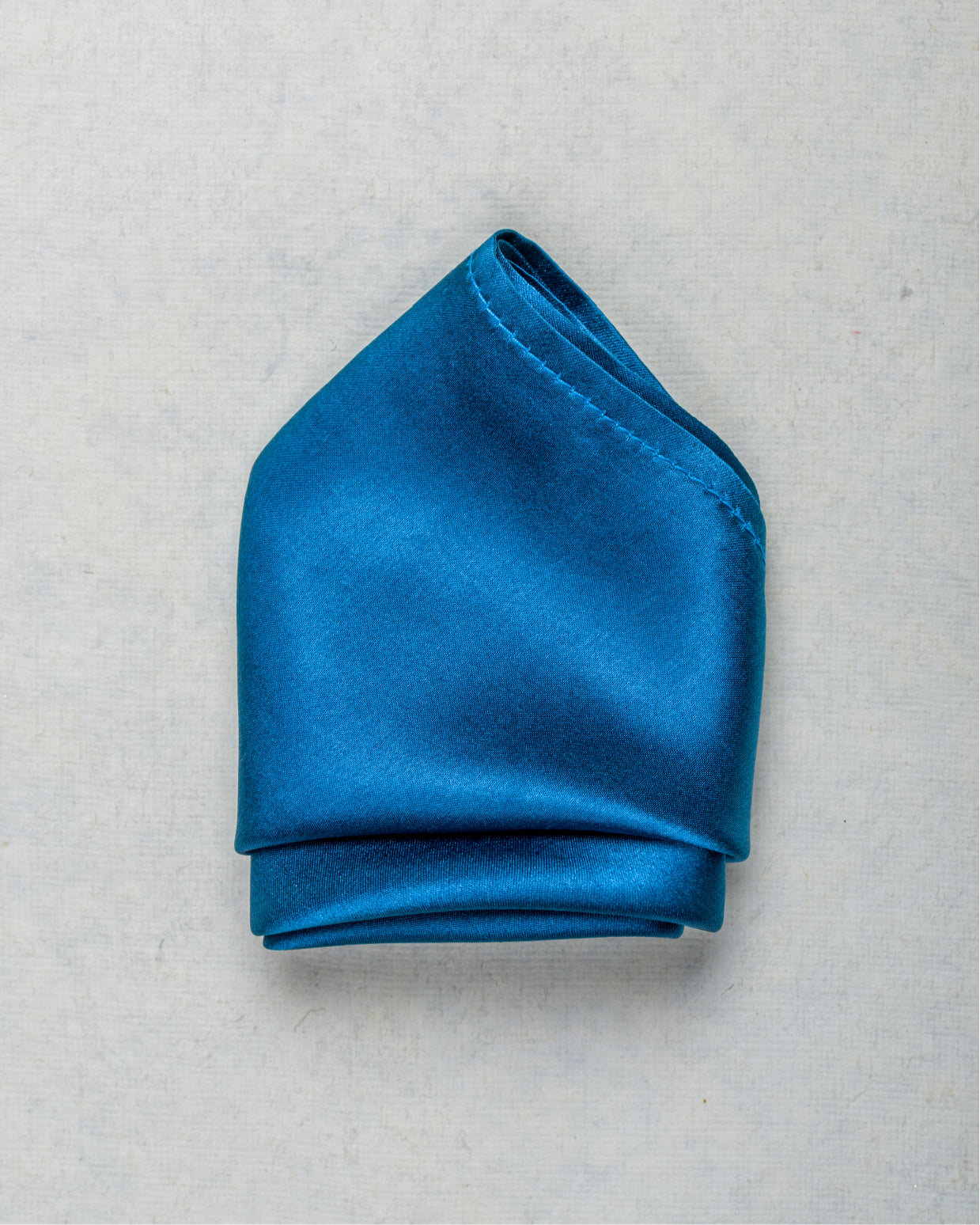 Folded teal blue satin silk pocket square