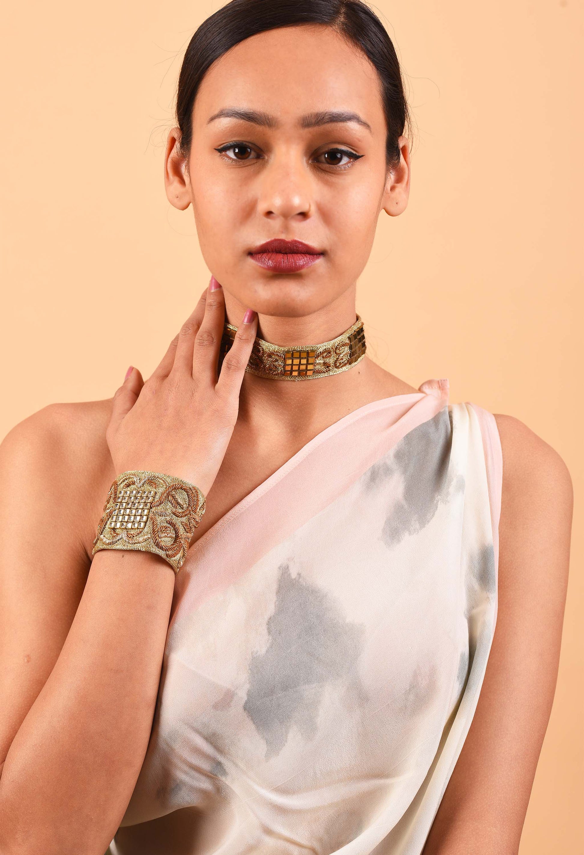 Woman wearing Freeque's handcrafted Dynasty choker and bracelet set, showcasing intricate Indian weaving traditions.
