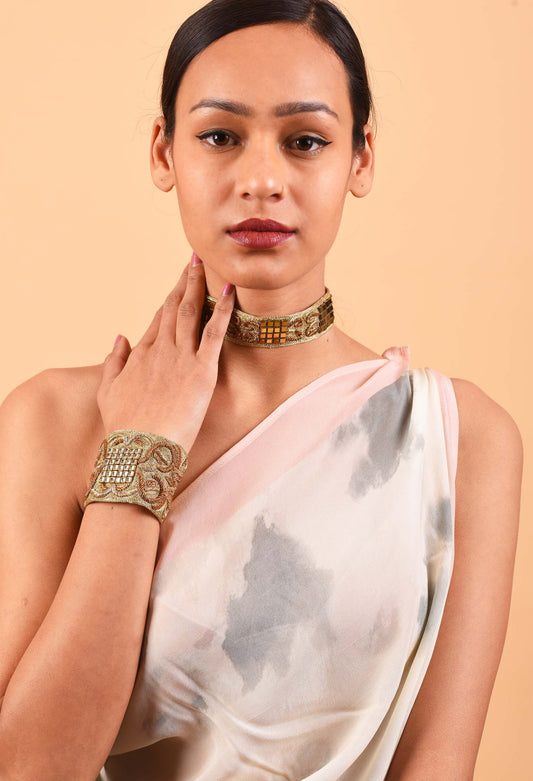 Woman wearing Freeque's handcrafted Dynasty choker and bracelet set, showcasing intricate Indian weaving traditions.