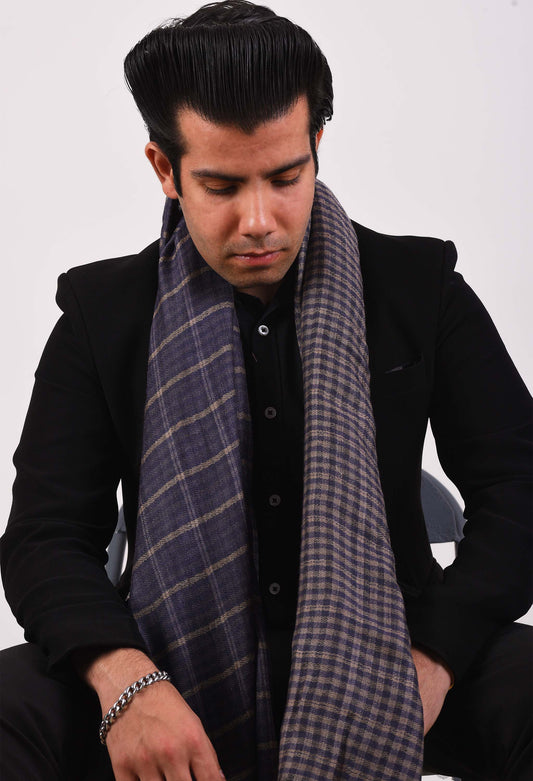 Model wearing Kai stole in camel wool, draped elegantly over a black suit.