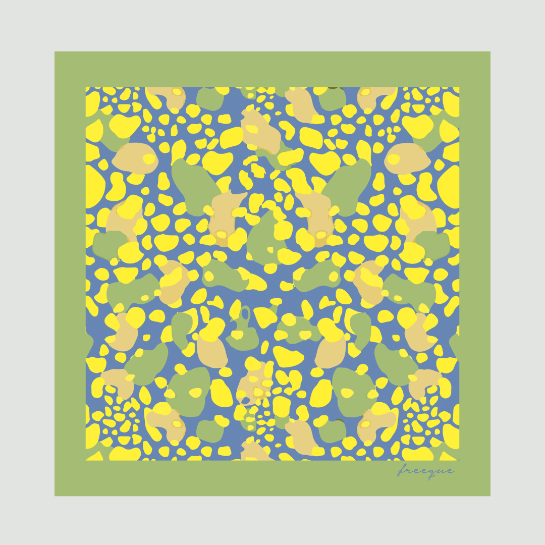 Mirage luxury scented scarf with vibrant yellow and blue pattern against a green border