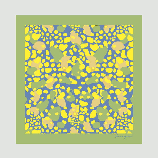 Mirage luxury scented scarf with vibrant yellow and blue pattern against a green border