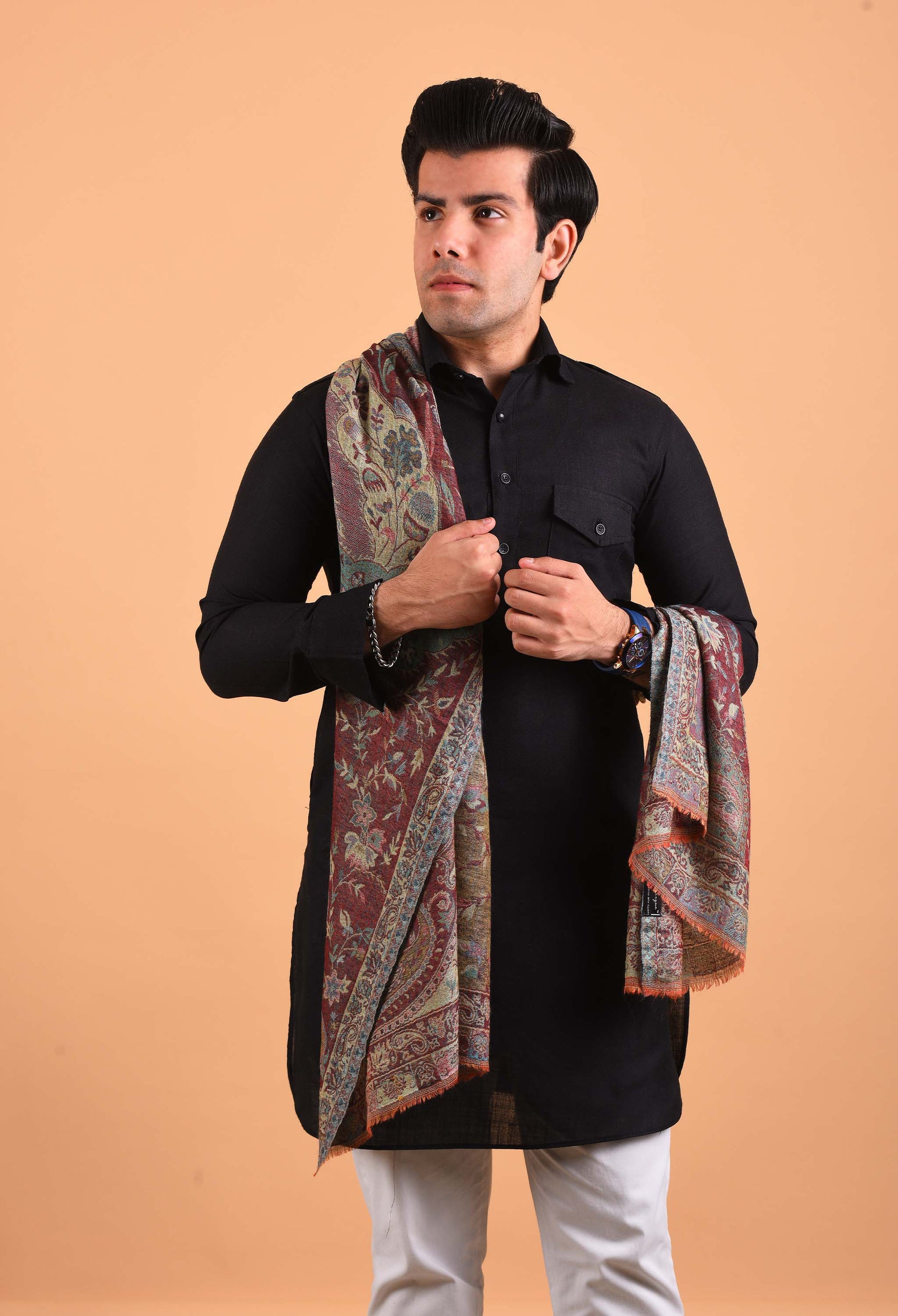 Model wearing Naadira camel wool shawl in intricate traditional pattern