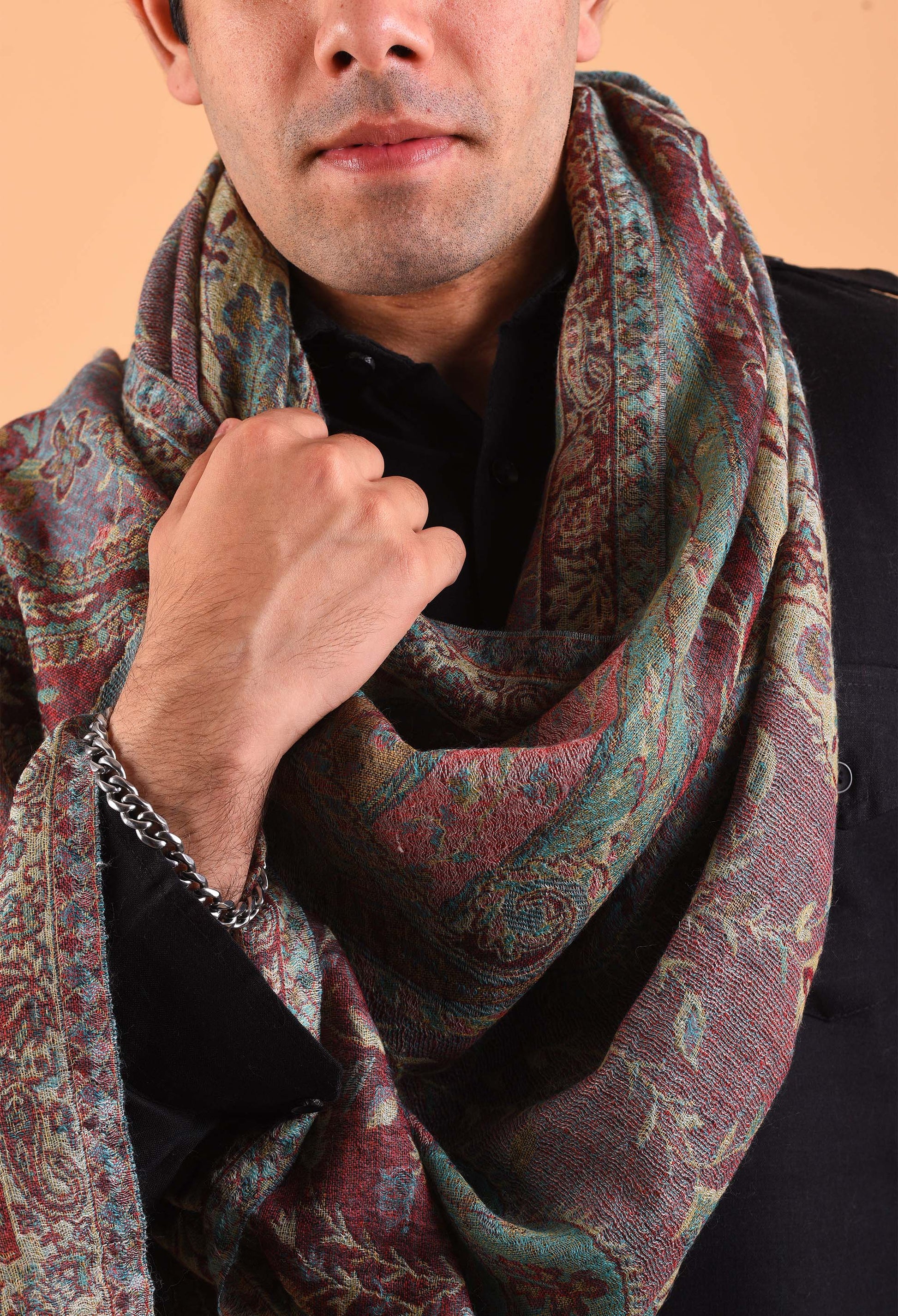 Naadira shawl held gracefully, focusing on rich pattern and fabric quality