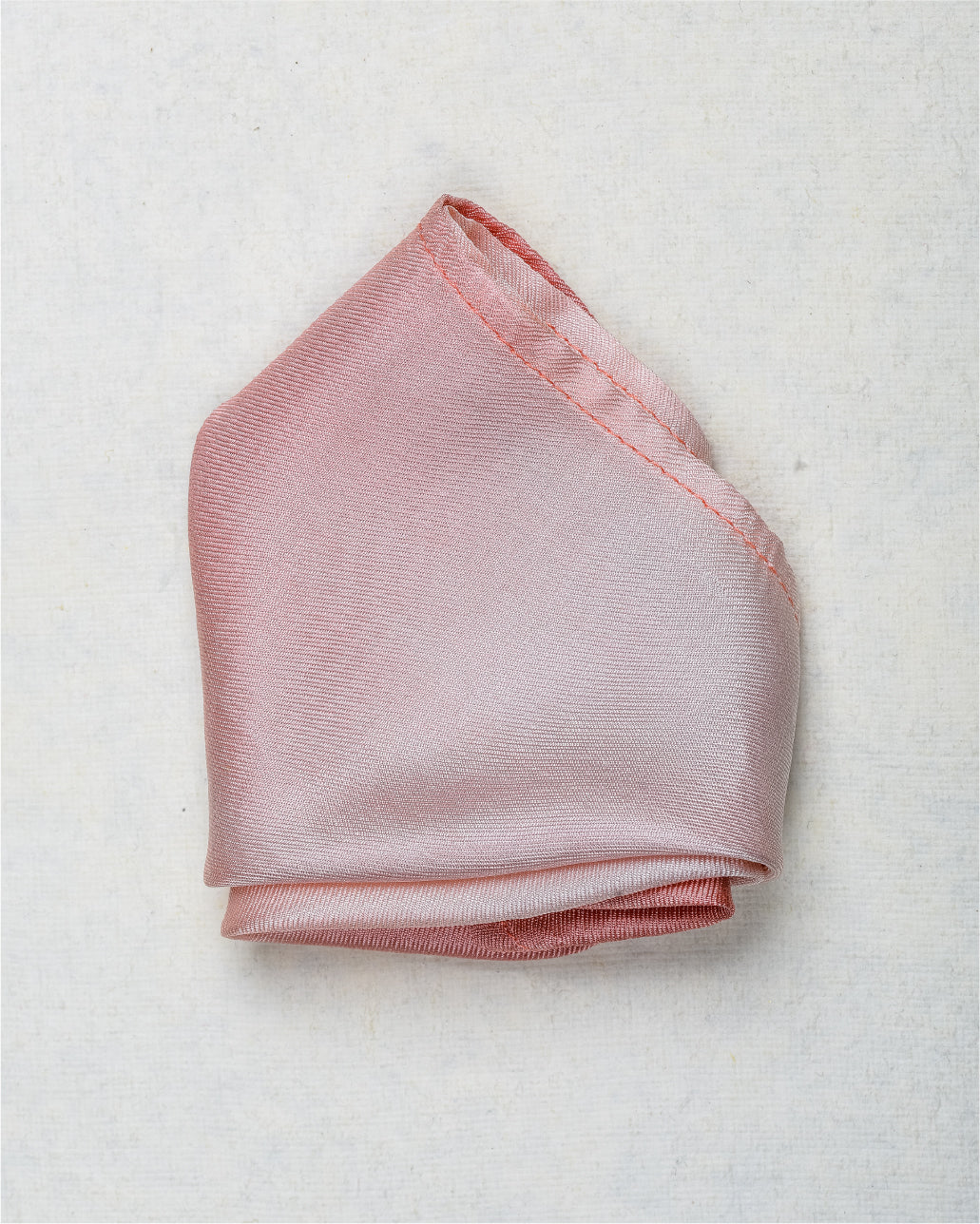 Close-up of Ombre rose gold  scented silk pocket square showing luxury fabric texture