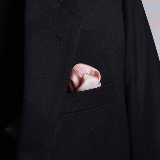 Ombre rose gold pocket square in a suit pocket, scented and made from luxurious silk twill