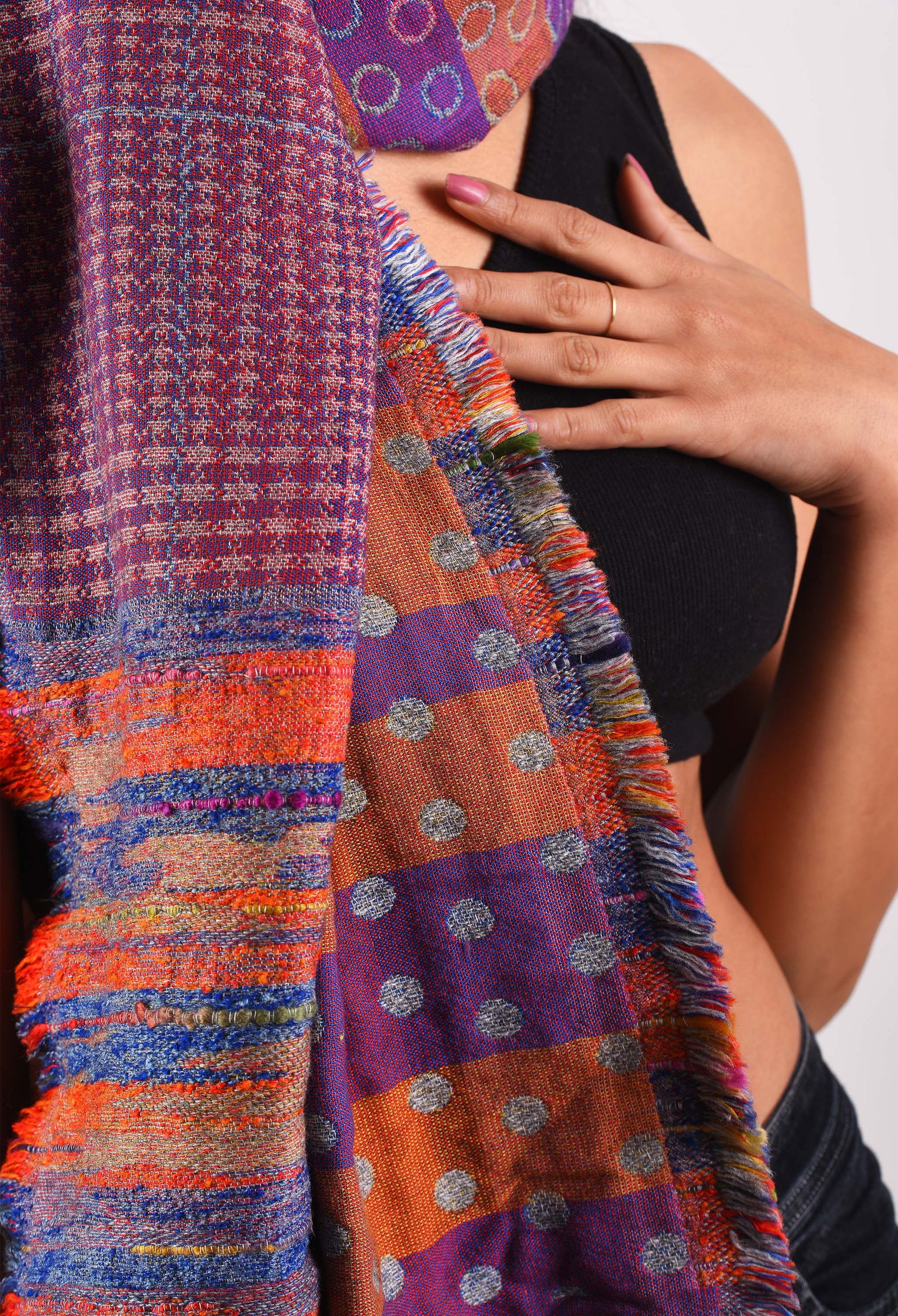 Close-up of detailed weave and vibrant patterns on camel wool Raha stole