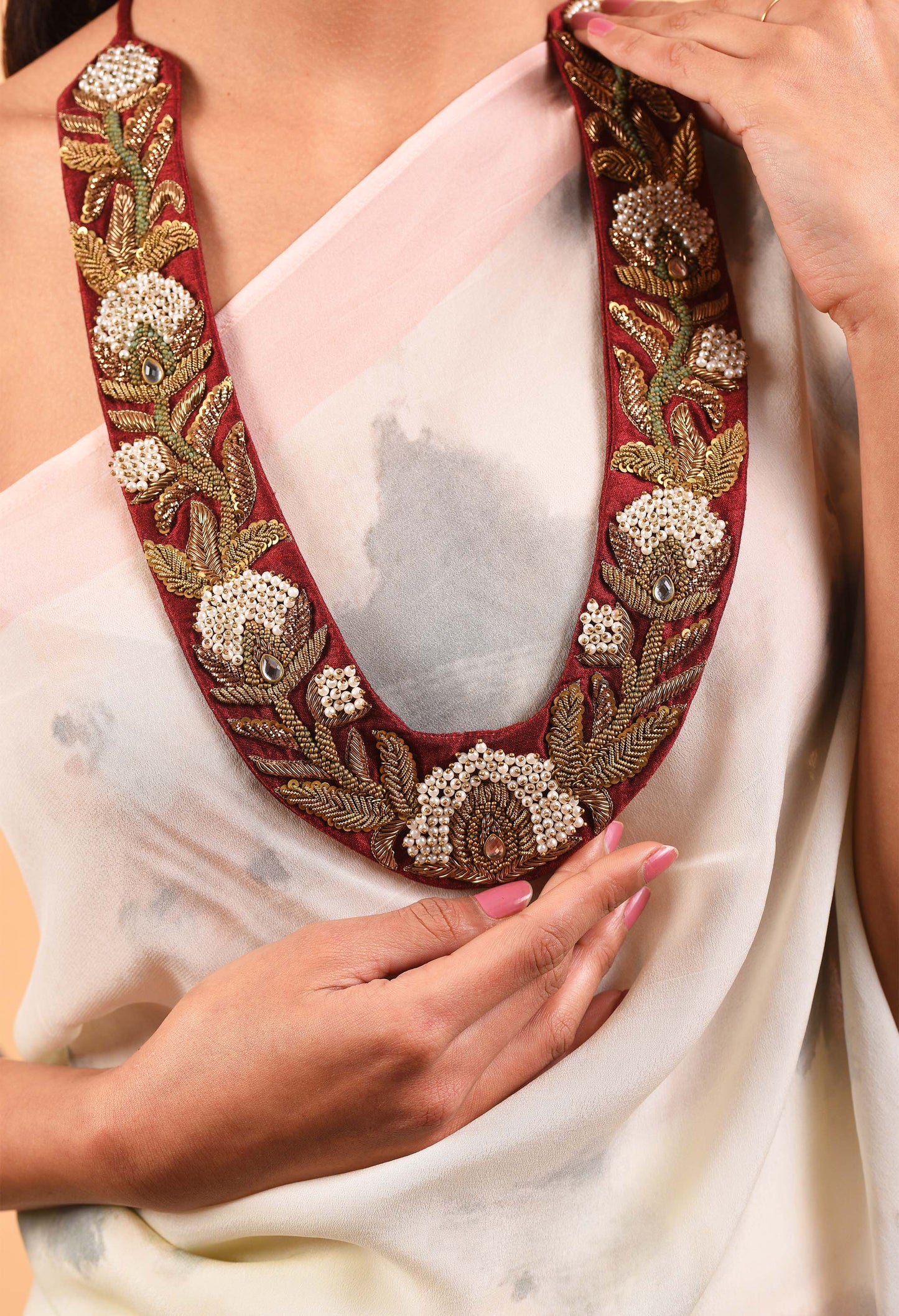 Close-up of intricate details on the Red Manor necklace from Freeque
