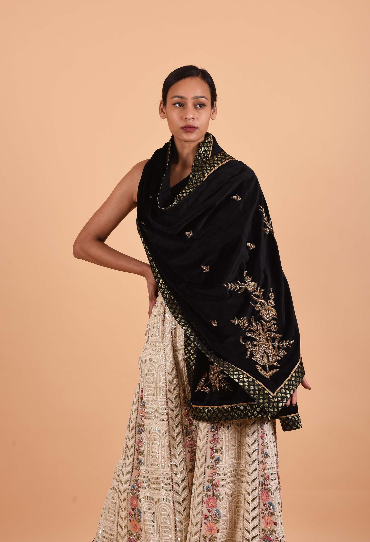 Model wearing a black Ruhani Suede Velvet Shawl with zardozi embroidery.