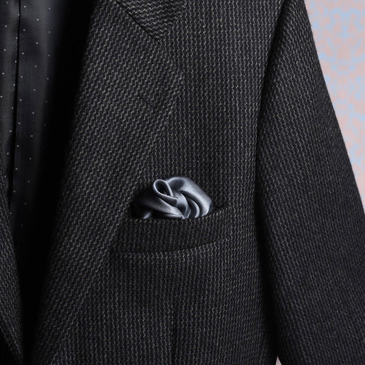 Solid grey satin silk scented pocket square in jacket pocket for a luxurious look.
