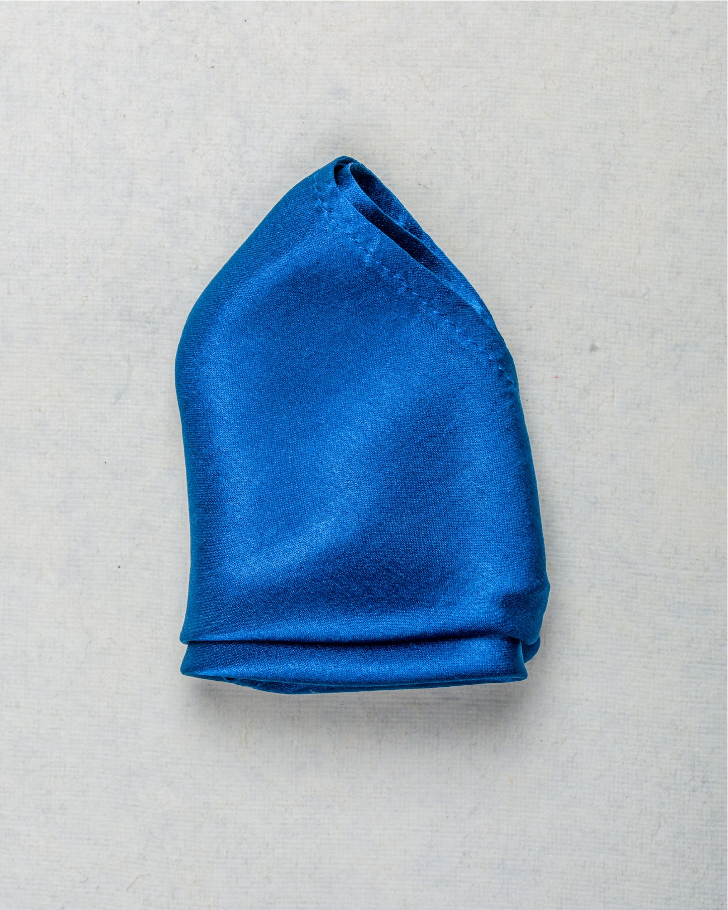 Close-up of solid indigo scented satin silk pocket square - Freeque