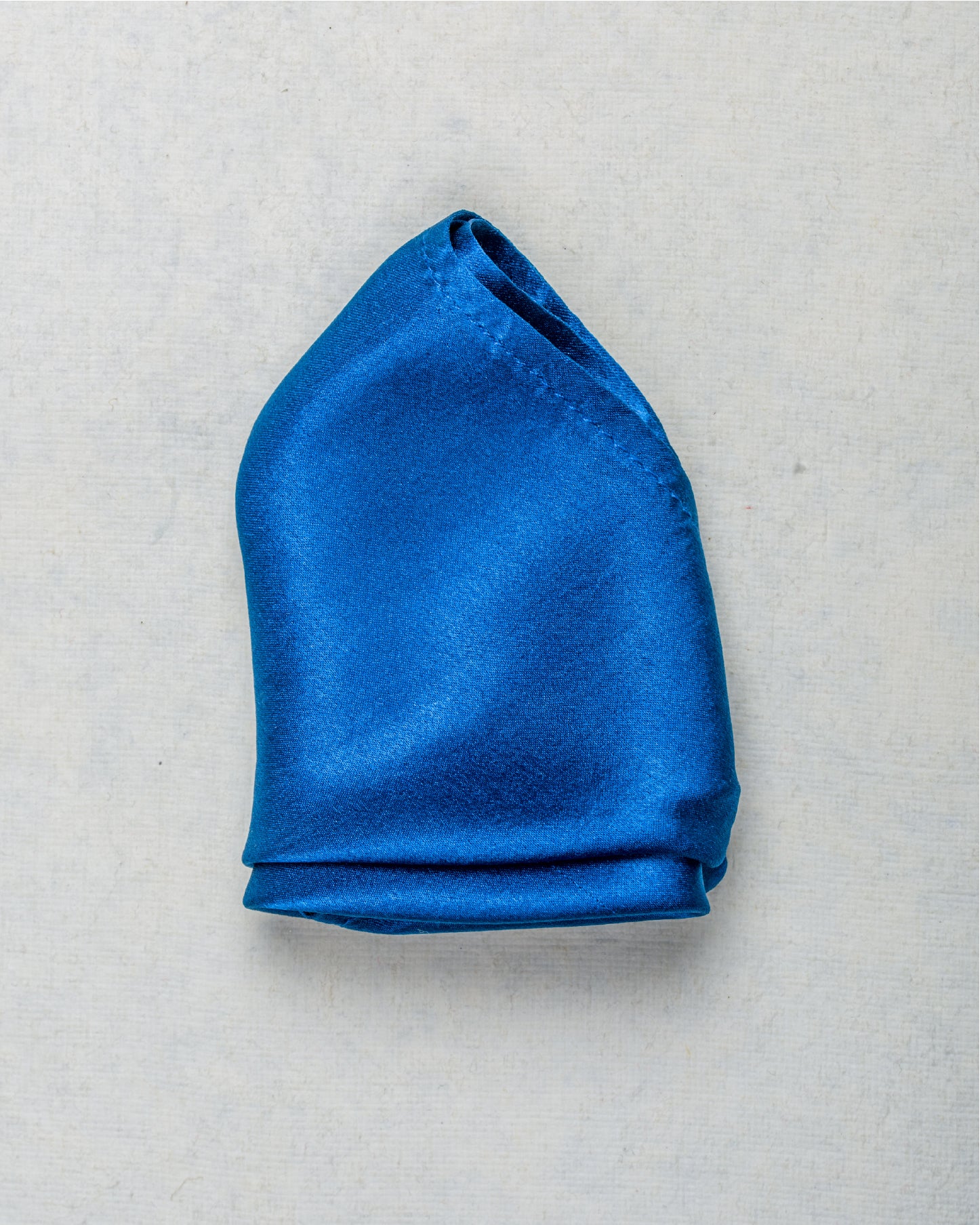 Close-up of solid indigo scented satin silk pocket square - Freeque