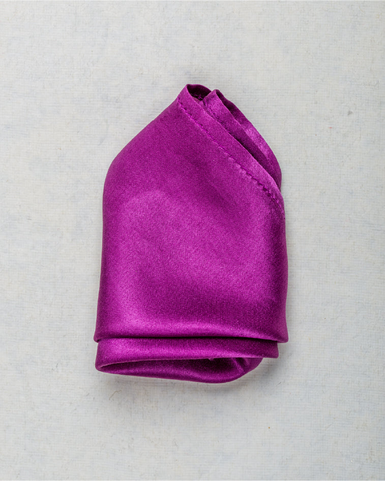 Close-up of solid magenta satin silk pocket square with rich gloss