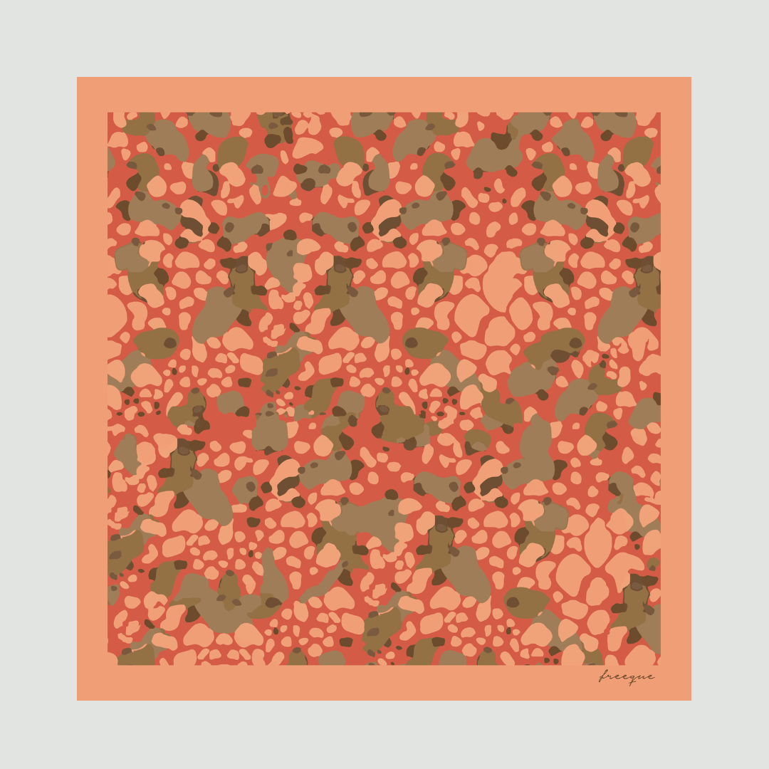 Flat lay of Strawberry Lush scarf showcasing its luxurious abstract pattern in red, green, and beige.