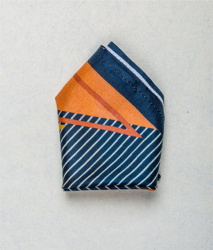 Close-up of the Striped Blue Yellow Pink pocket square showcasing its vibrant colors and fragrance-infused fabric