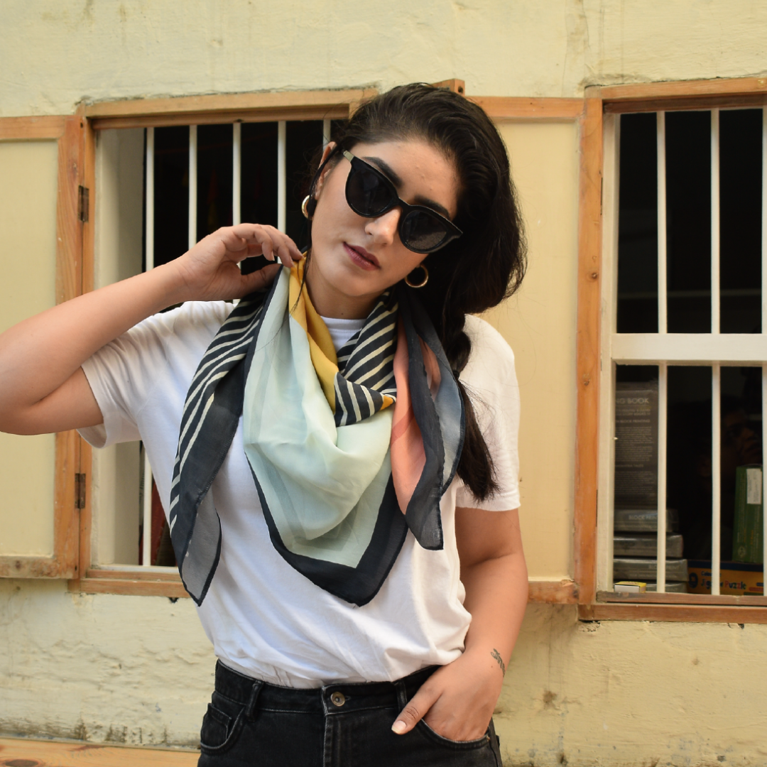Woman styling Freeque Striped Sundae scented scarf around her neck in a casual look