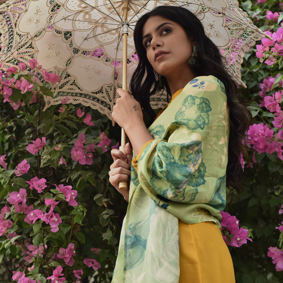 Model holding Tender Cosmo scented silk stole with green floral design under a lace umbrella