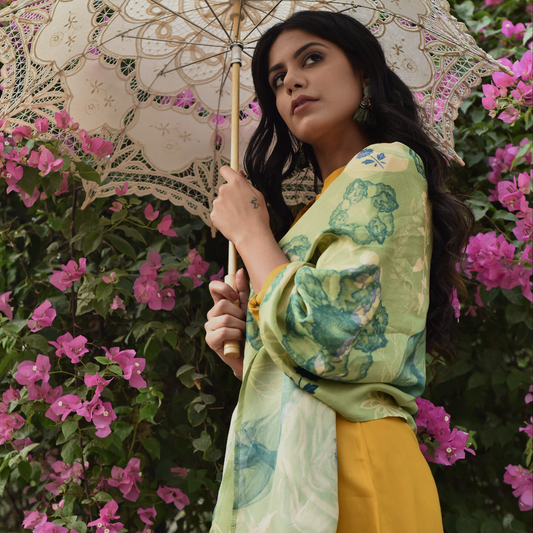Model holding Tender Cosmo scented silk stole with green floral design under a lace umbrella